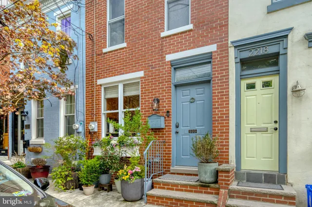 front view of a house with potted plants