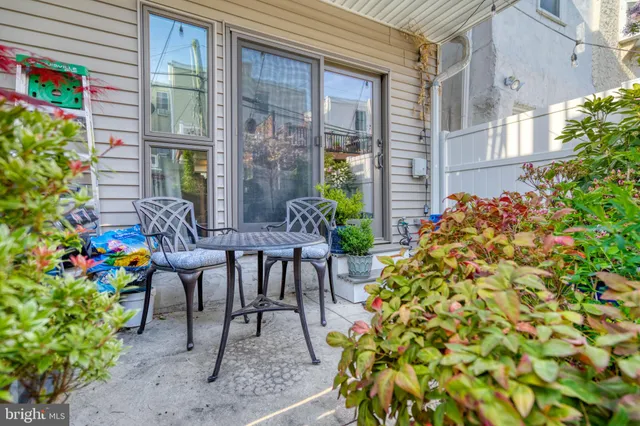 a view of a patio with table and chairs and potted plants