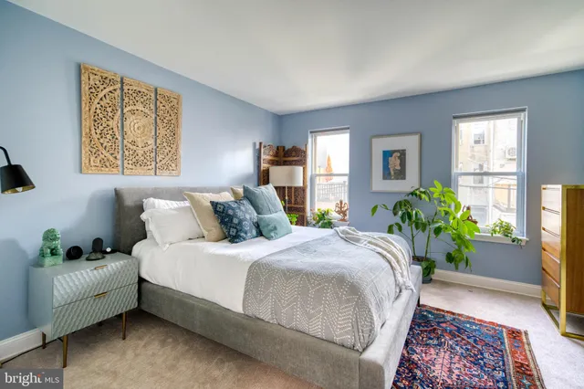 a bedroom with bed and a couch