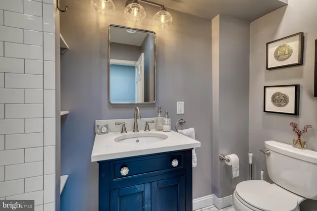 a bathroom with a toilet a sink and mirror