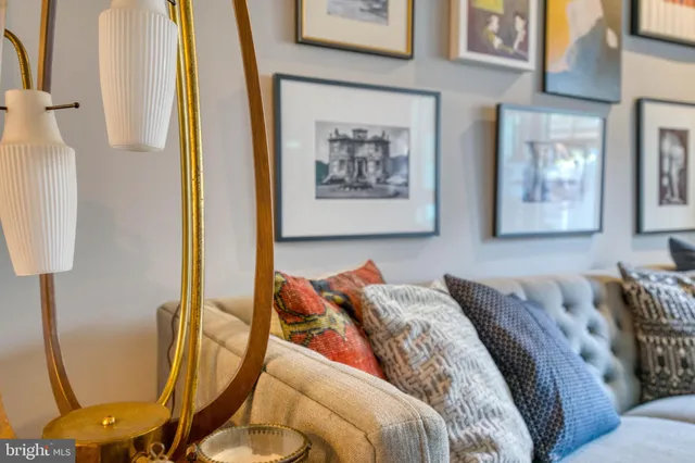 a living room with furniture and a mirror