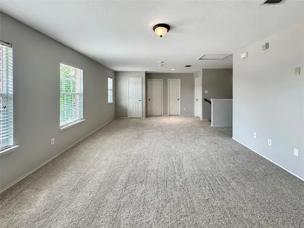 a view of a livingroom with a kitchen and window
