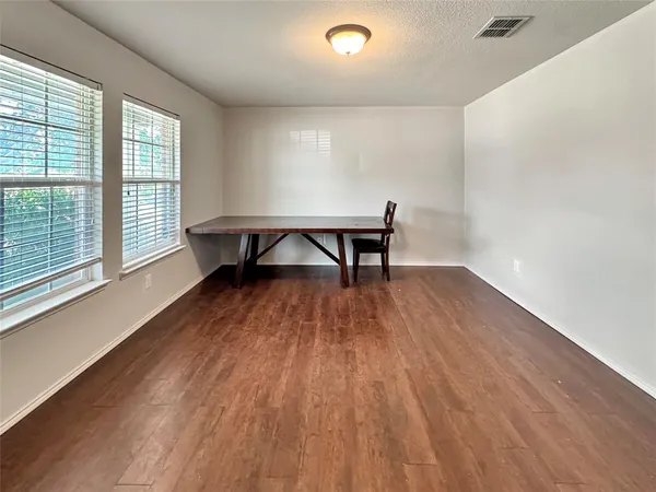 a view of a room with wooden floor and a window