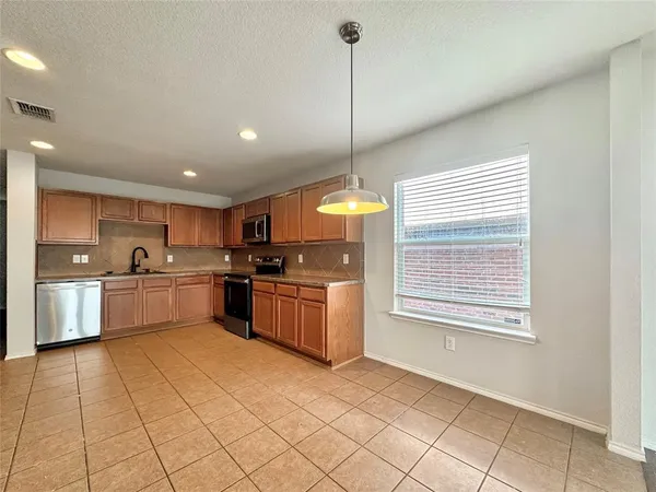 a kitchen with a sink cabinets and window
