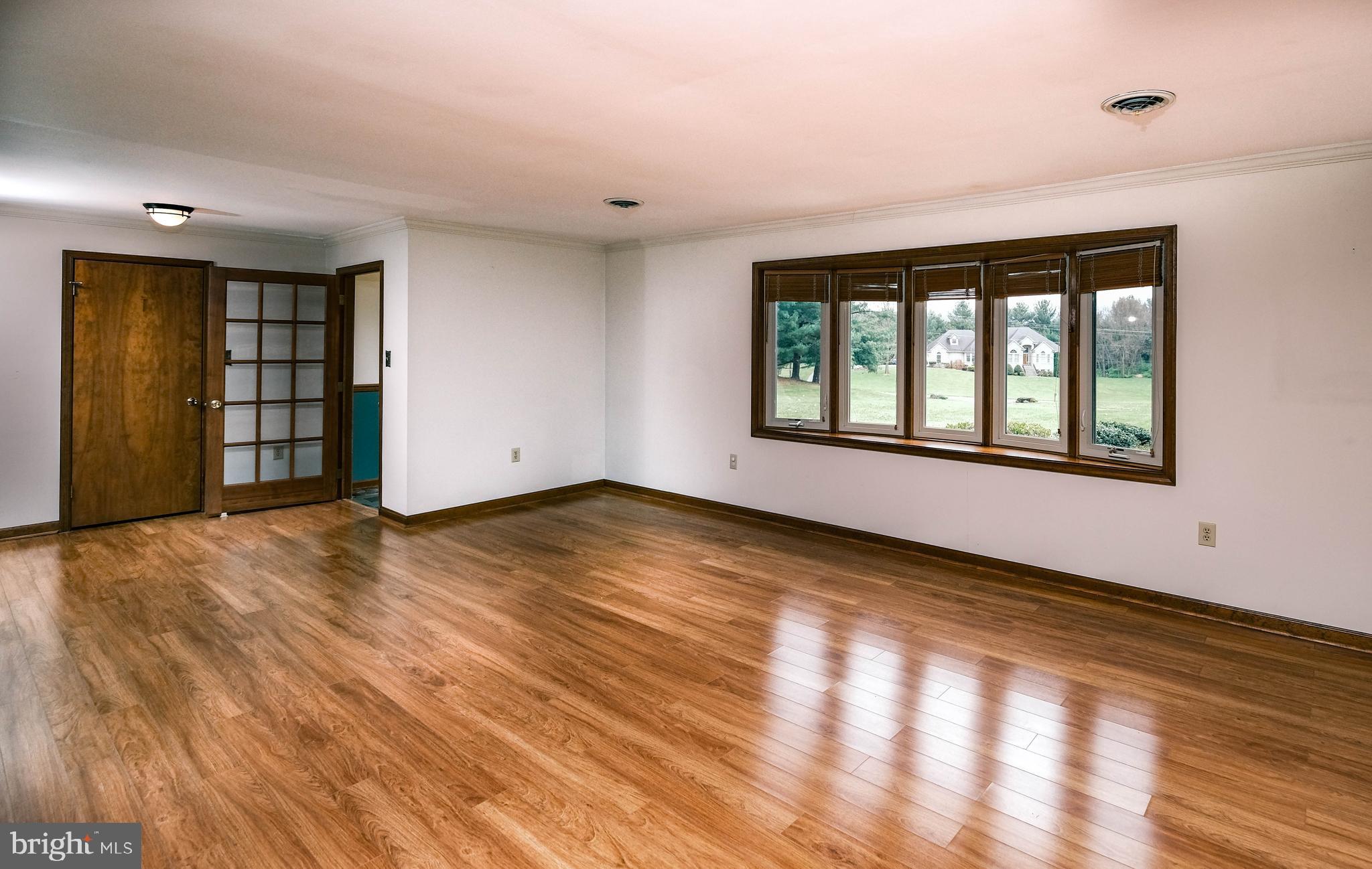 225 Bowling Green Road Front Royal, VA 22630 - Photo 18 of 77 an empty room with wooden floor and windows