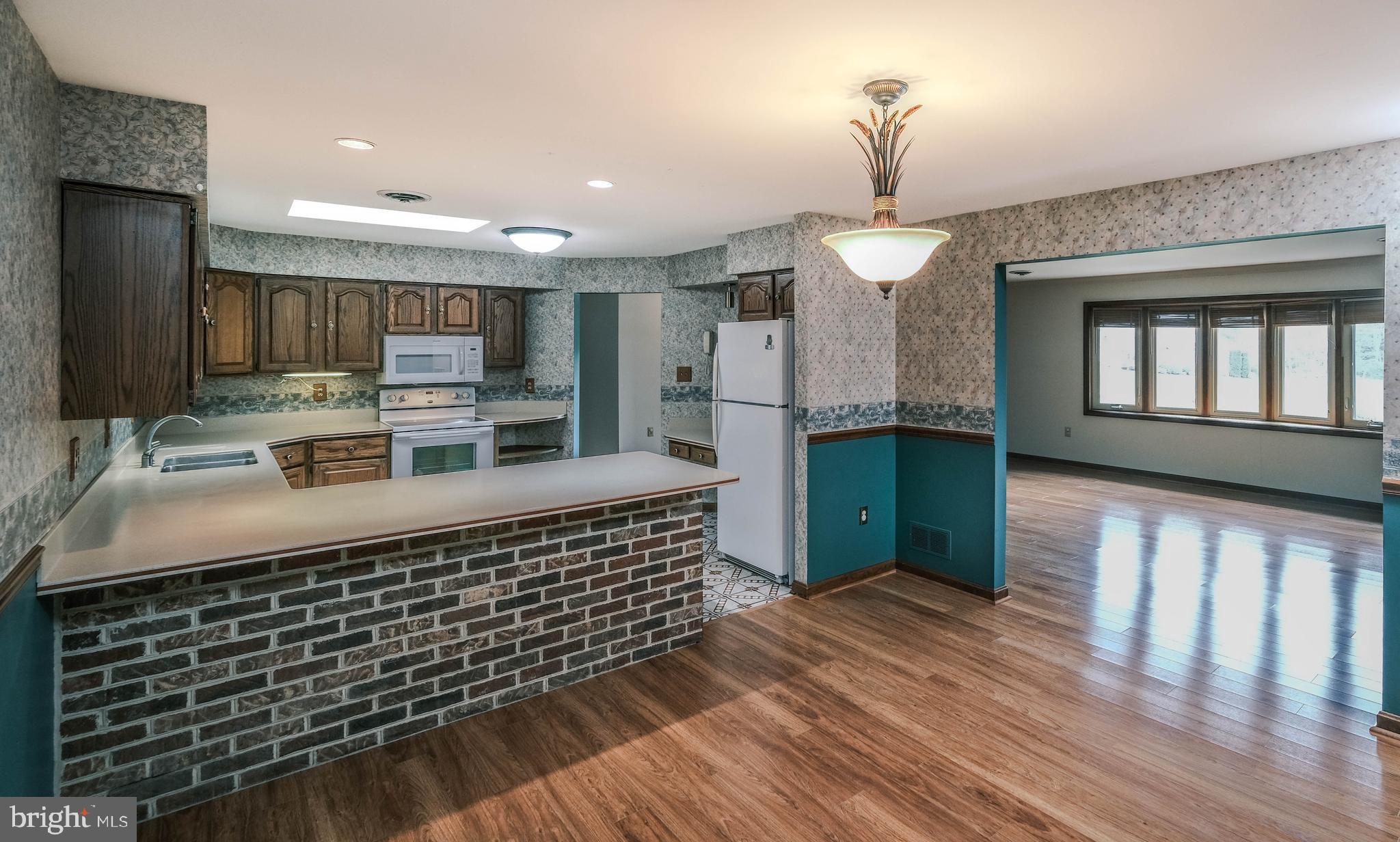 225 Bowling Green Road Front Royal, VA 22630 - Photo 29 of 77 a kitchen with kitchen island stainless steel appliances a sink stove and refrigerator