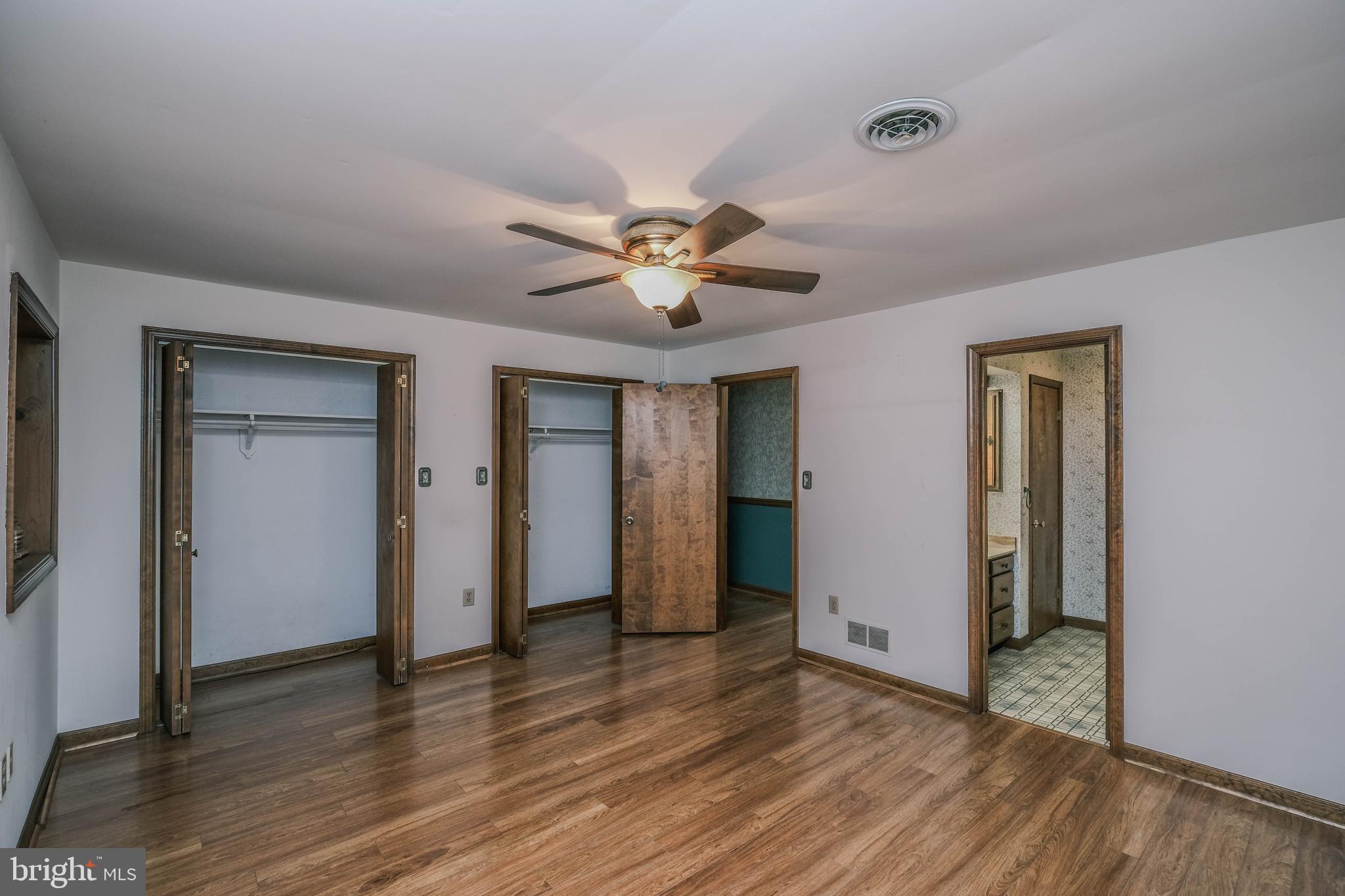 225 Bowling Green Road Front Royal, VA 22630 - Photo 33 of 77 an empty room with wooden floor and a ceiling fan