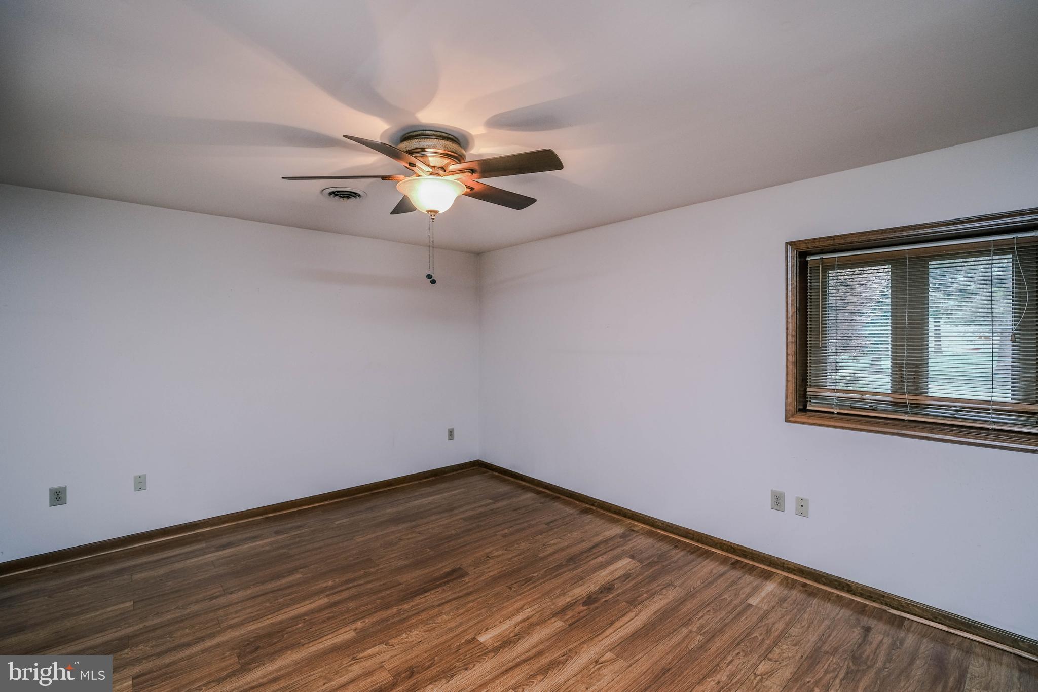 225 Bowling Green Road Front Royal, VA 22630 - Photo 36 of 77 a view of empty room with wooden floor and fan