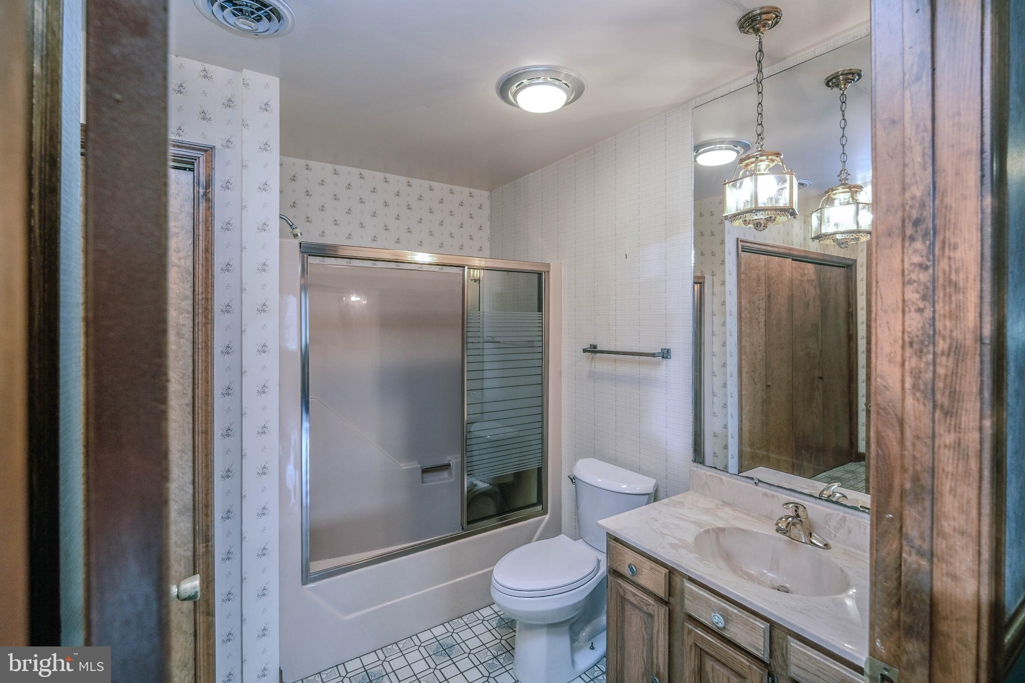 225 Bowling Green Road Front Royal, VA 22630 - Photo 38 of 77 a bathroom with a granite countertop sink toilet and shower