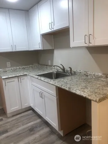 a kitchen with granite countertop cabinets and sink