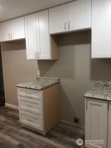 a stove top oven sitting inside of a kitchen