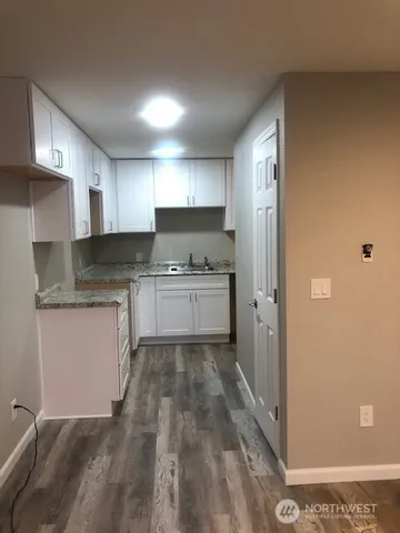 a kitchen with a sink a refrigerator and cabinets
