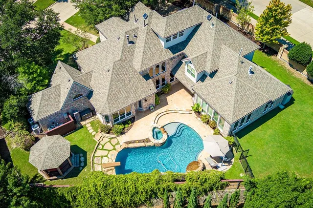 an aerial view of residential house with outdoor space and swimming pool