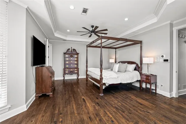 a bedroom with furniture and wooden floor