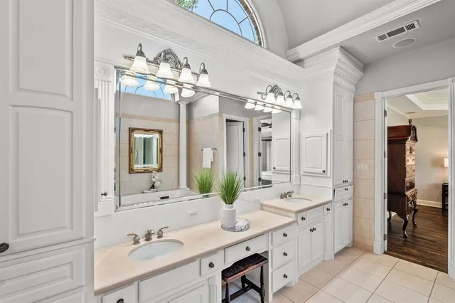 a bathroom with a double vanity sink and a mirror