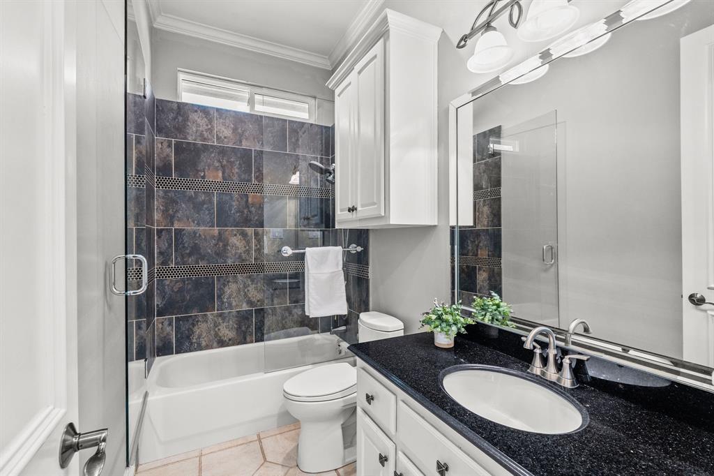 1101 Trail Ridge Drive McKinney, TX 75072 - Photo 29 of 37 a bathroom with a sink a toilet a mirror and bathtub