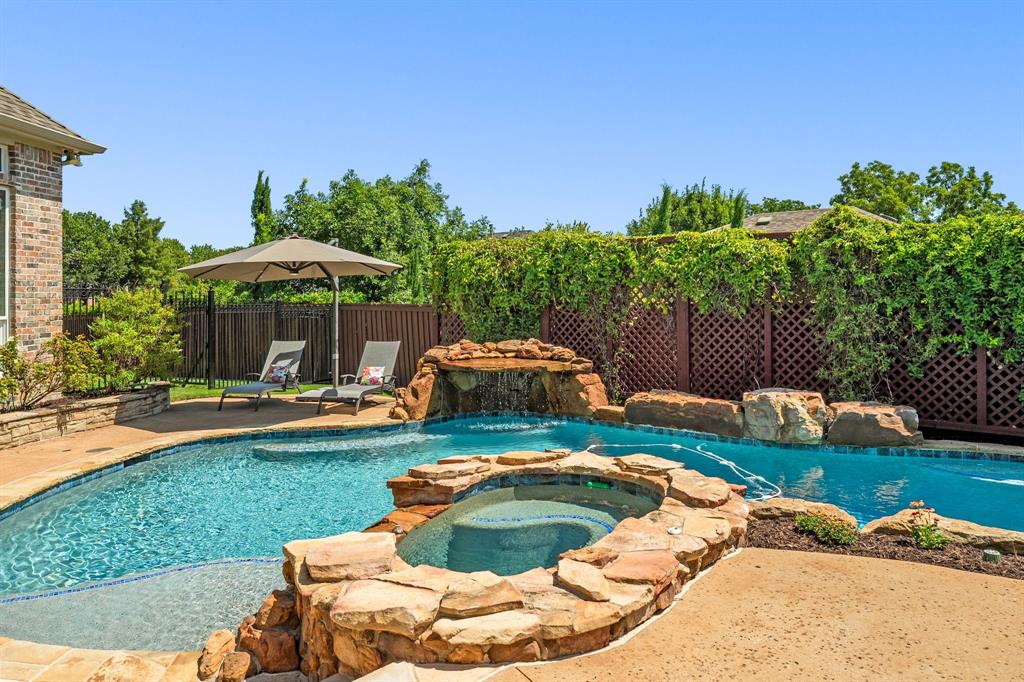 1101 Trail Ridge Drive McKinney, TX 75072 - Photo 3 of 37 a backyard of a house with table and chairs under an umbrella