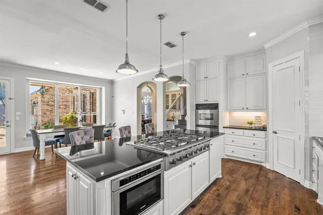 a kitchen with stainless steel appliances granite countertop a stove and a sink