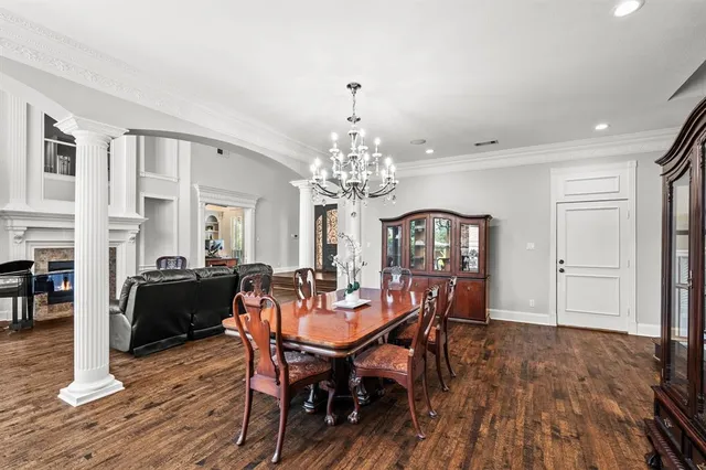 a view of a dining room with furniture and chandelier