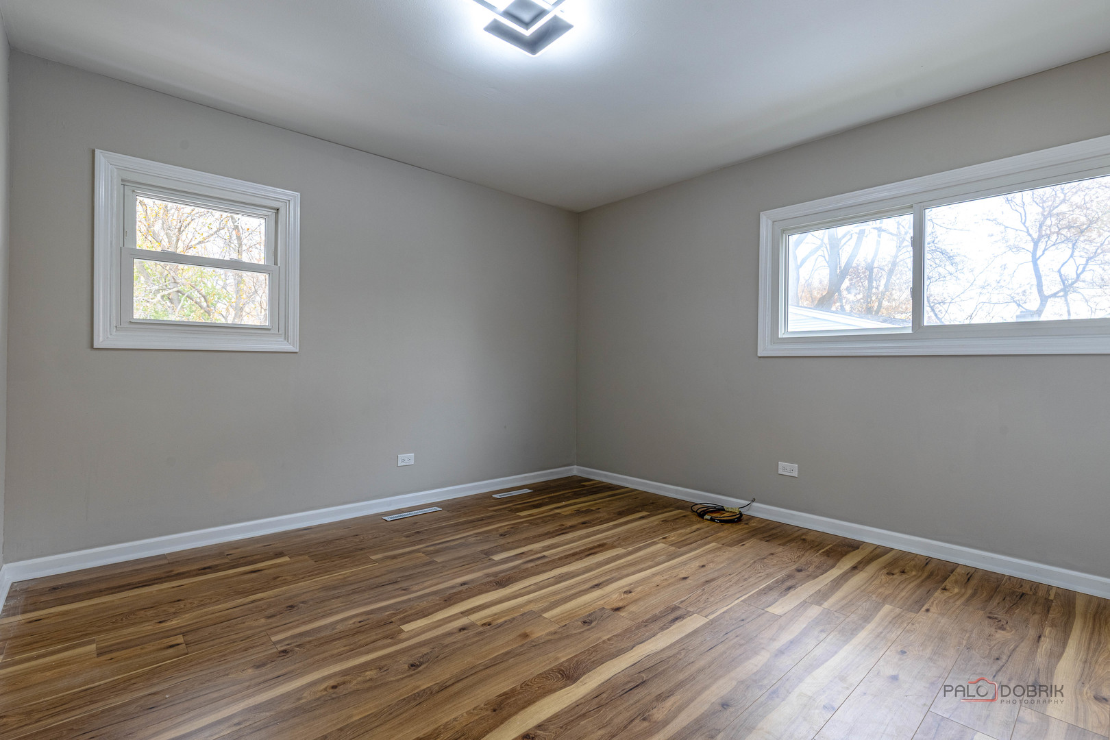 1096 Beechwood Road Buffalo Grove, IL 60089 - Photo 15 of 26 a view of an empty room with wooden floor and a window