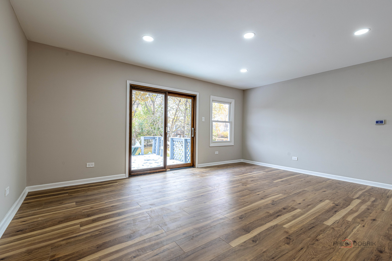 1096 Beechwood Road Buffalo Grove, IL 60089 - Photo 6 of 26 a view of an empty room with wooden floor and a window