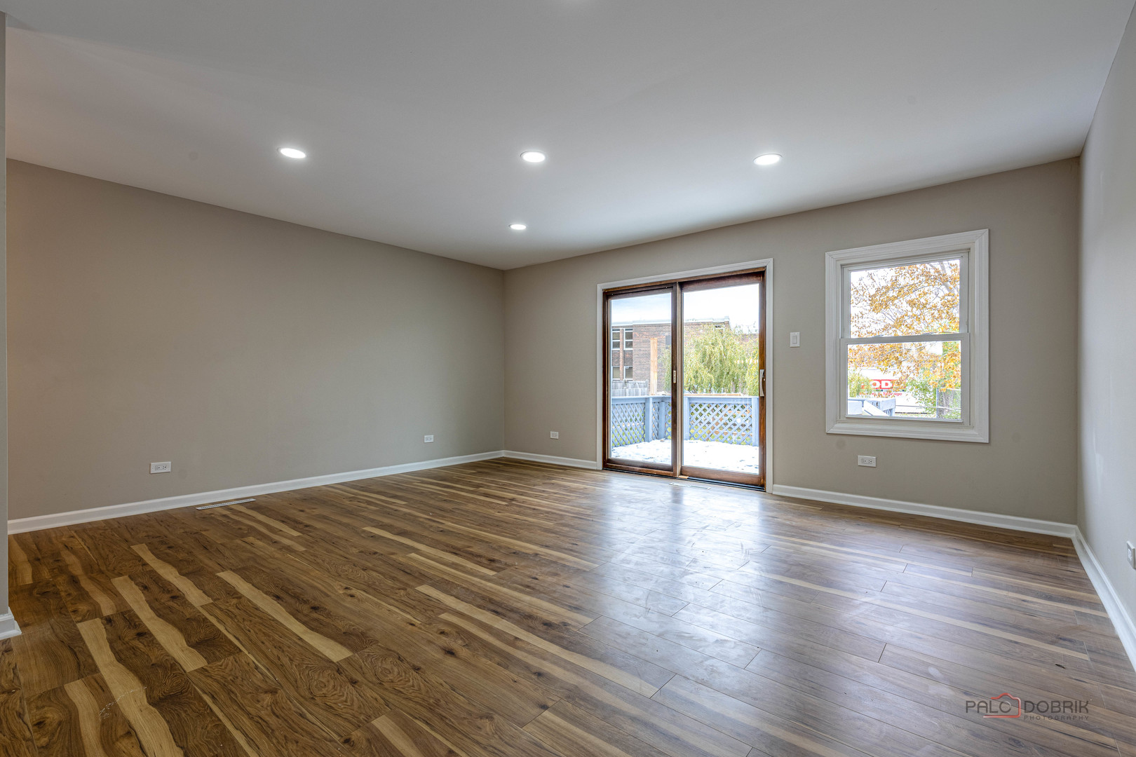 1096 Beechwood Road Buffalo Grove, IL 60089 - Photo 8 of 26 a view of an empty room with wooden floor and a window