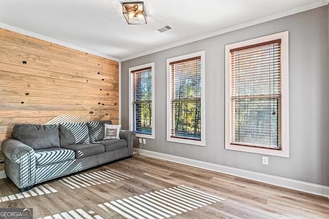 a living room with furniture and wooden floor
