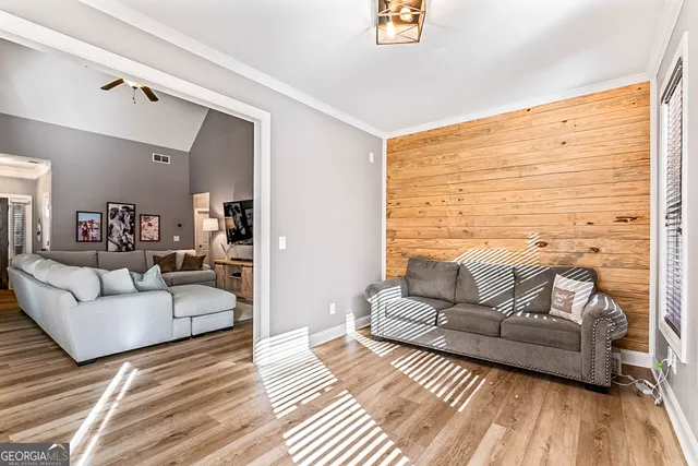 a bedroom with a large bed and a chandelier fan