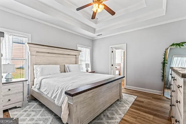 a bedroom with a bed and a chandelier