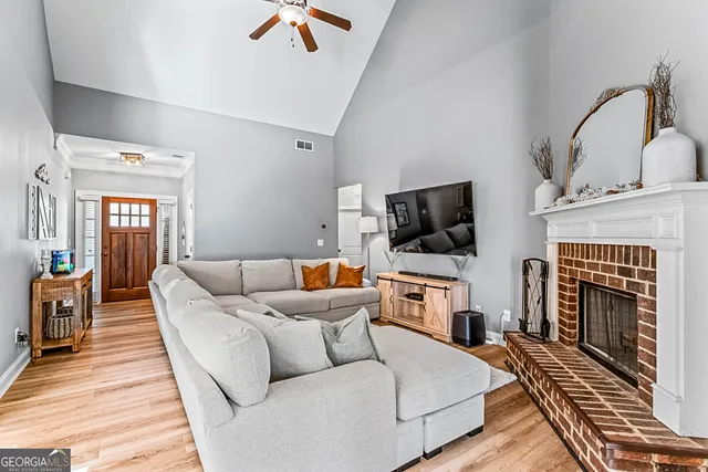 a living room with furniture and kitchen view