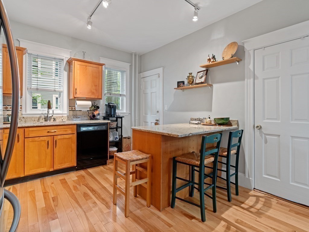 68 Parkton Road, Unit 1 Boston, MA 02130 - Photo 7 of 22 a kitchen with a table chairs sink and cabinets