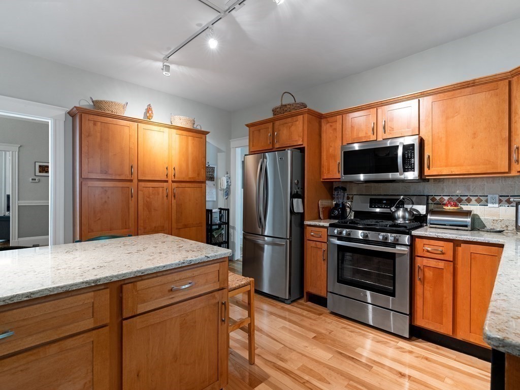 68 Parkton Road, Unit 1 Boston, MA 02130 - Photo 9 of 22 a kitchen with stainless steel appliances granite countertop a refrigerator stove and microwave