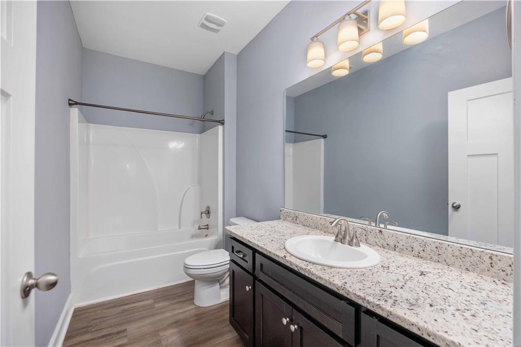 70 Apache Trail Fort Mitchell, AL 36856 - Photo 12 of 33 Full bath with vanity, shower / bath combination, and dark wood-type flooring
