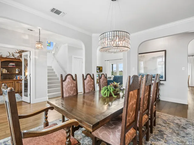 a living room with furniture a fireplace and a floor to ceiling window