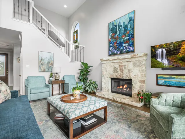 a spacious bathroom with a sink a large mirror and a potted plant
