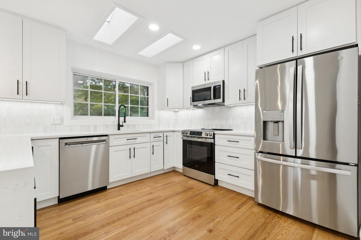 3209 Military Road Arlington, VA 22207 - Photo 11 of 45 a kitchen with granite countertop stainless steel appliances a refrigerator cabinets and a sink