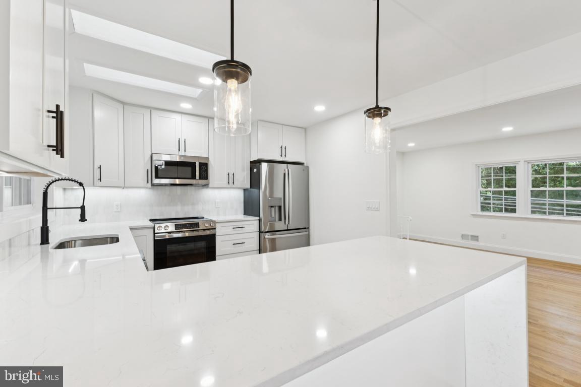 3209 Military Road Arlington, VA 22207 - Photo 14 of 45 a kitchen with stainless steel appliances a sink stove and refrigerator
