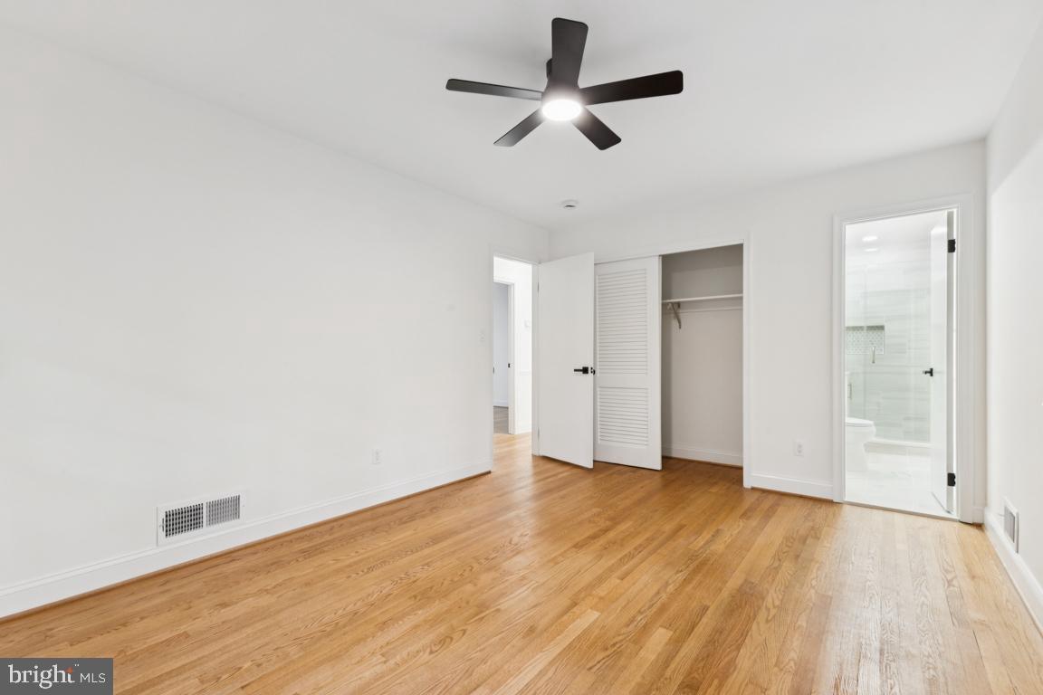3209 Military Road Arlington, VA 22207 - Photo 25 of 45 an empty room with wooden floor and ceiling fan