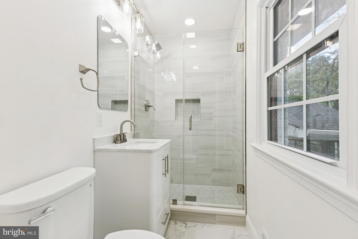 3209 Military Road Arlington, VA 22207 - Photo 26 of 45 a bathroom with a sink a toilet and shower