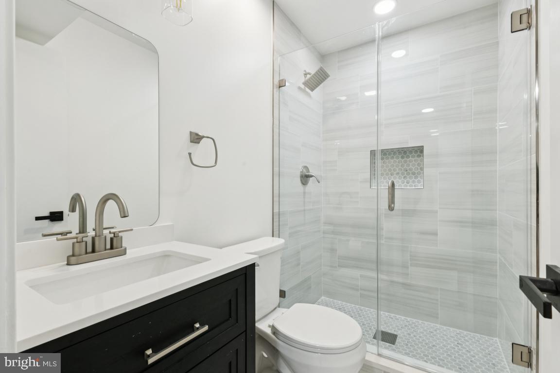 3209 Military Road Arlington, VA 22207 - Photo 29 of 45 a bathroom with a sink a toilet and shower