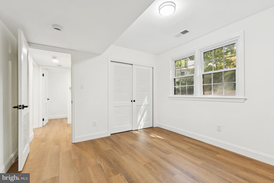 3209 Military Road Arlington, VA 22207 - Photo 34 of 45 an empty room with wooden floor and windows