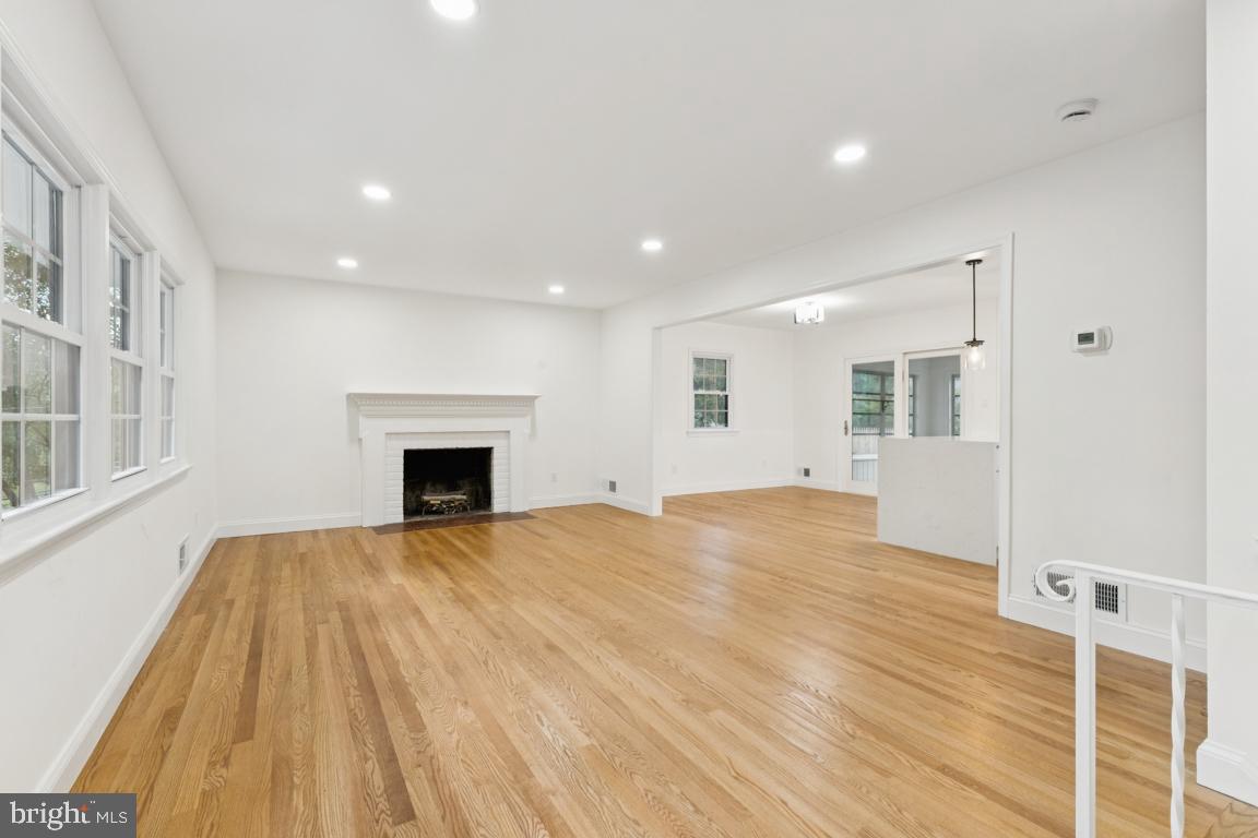 3209 Military Road Arlington, VA 22207 - Photo 6 of 45 a view of an empty room with wooden floor and a fireplace