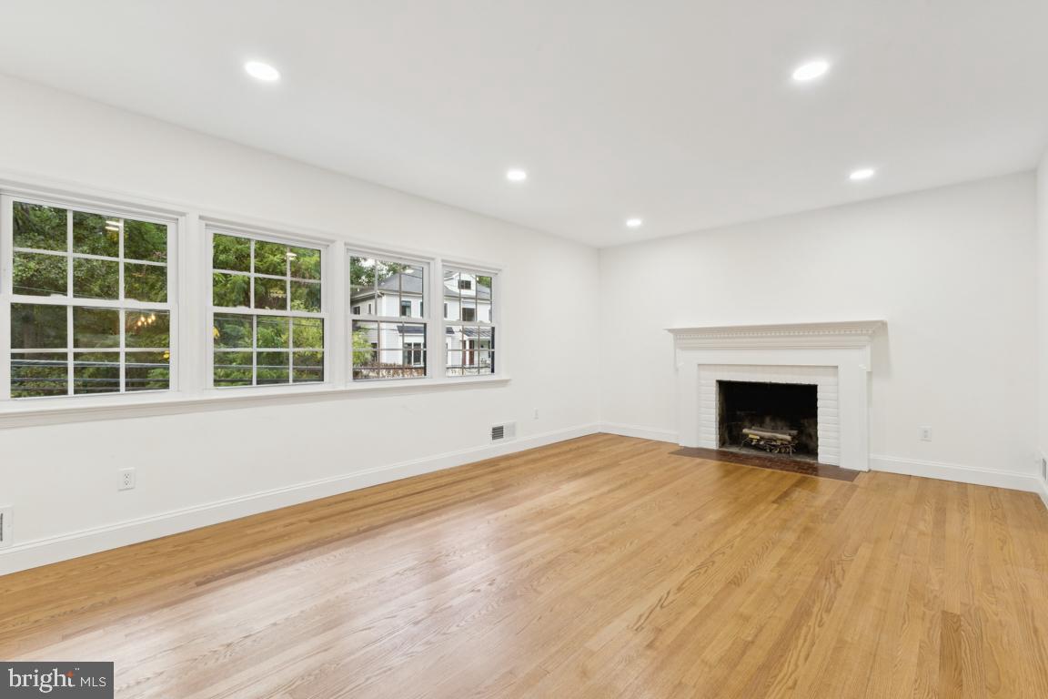 3209 Military Road Arlington, VA 22207 - Photo 7 of 45 a view of an empty room with a window and fireplace
