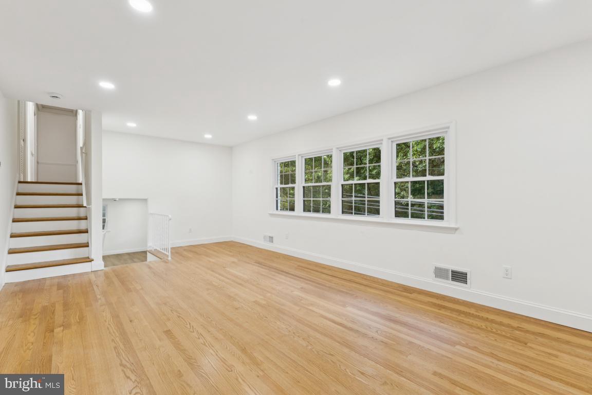 3209 Military Road Arlington, VA 22207 - Photo 8 of 45 a view of an empty room with a window and wooden floor