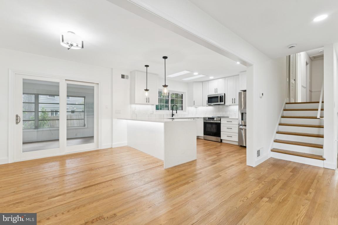 3209 Military Road Arlington, VA 22207 - Photo 9 of 45 a view of a kitchen with wooden floor electronic appliances and stairs