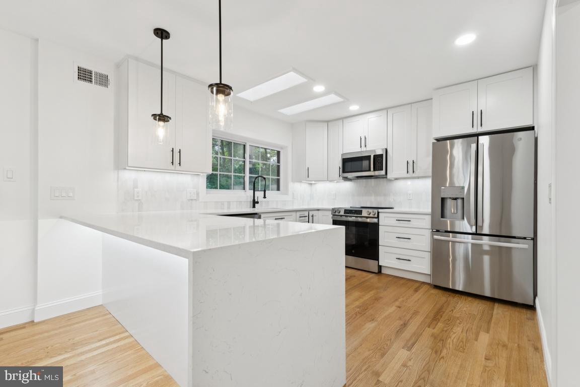3209 Military Road Arlington, VA 22207 - Photo 10 of 45 a kitchen with stainless steel appliances a refrigerator sink and microwave