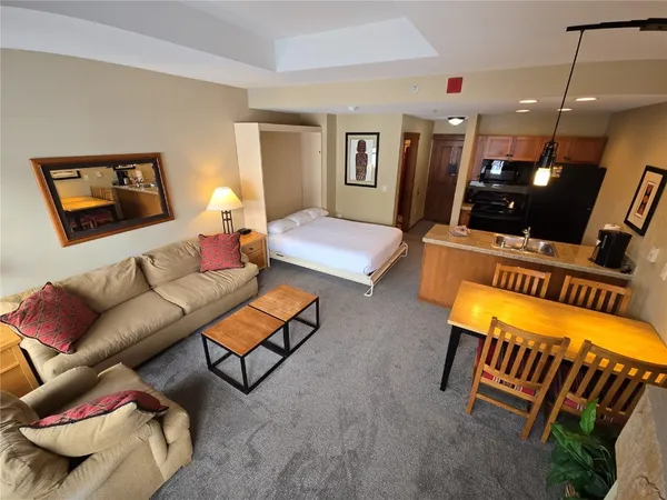 a bedroom with furniture and a painting on the wall