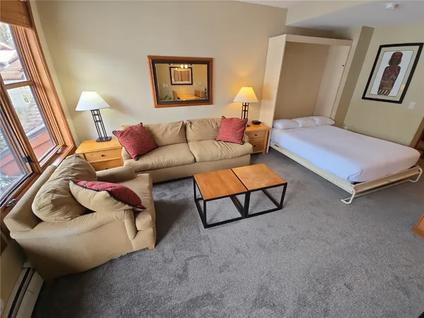a bedroom with furniture and a bathroom