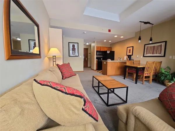 a living room with furniture pool table and window