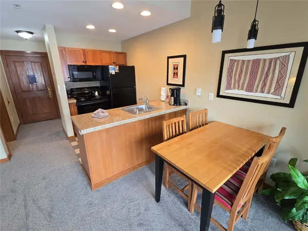 a room with furniture pool table and window